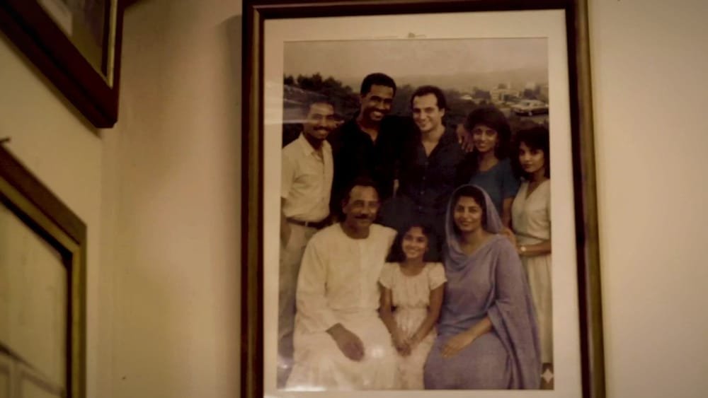 An old family photograph in a frame on the wall. A frame from Amal in Italy.