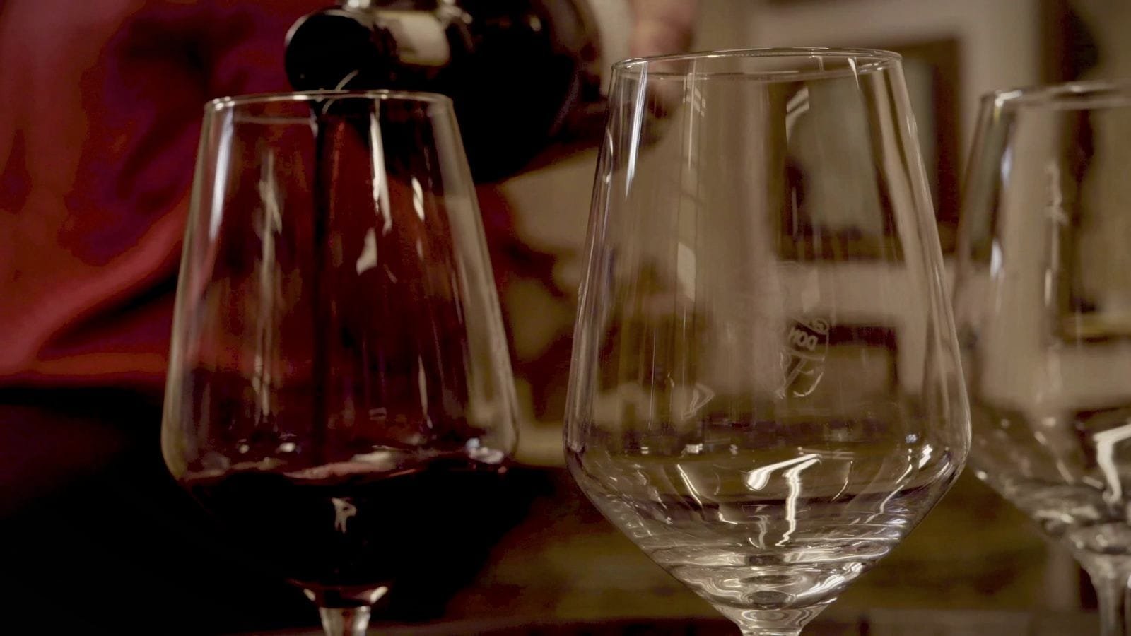 Red wine is poured into a glass. A frame from Amal in Italy.